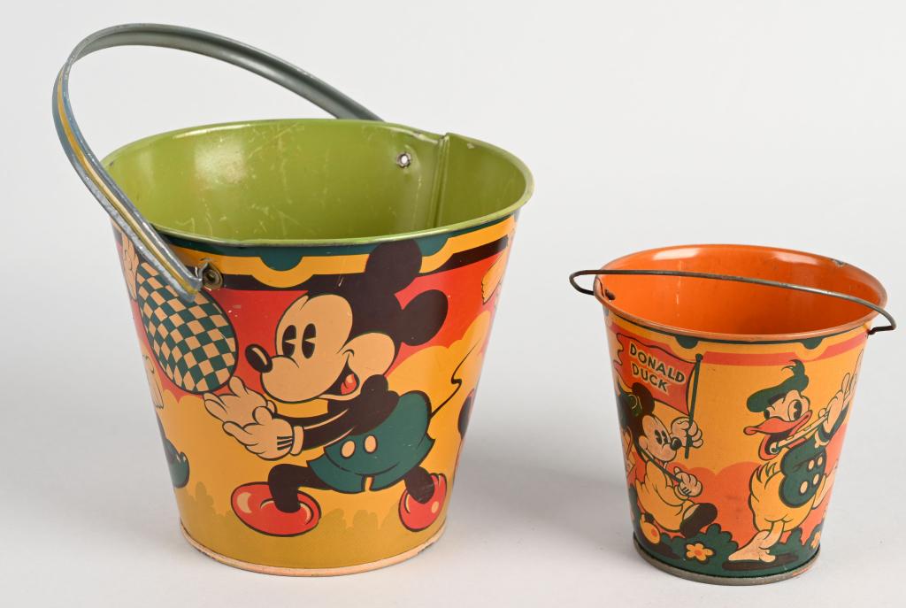 2- 1930's WALT DISNEY SAND PAILS, MICKEY & DONALD: Colorful new old stock sand pails made by Happnack, England in the 1930's. The larger pail features pie eyed Mickey and Minnie Mouse, the smaller pail has Mickey Mouse, Donald Duck and other character
