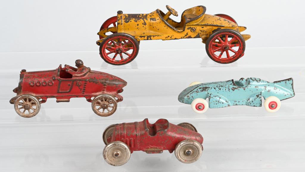 4- VINTAGE cast iron RACE CARS: Nice lot includes scarce red Friedag Race car missing driver, and 2 versions f the A.C. Williams Race car. The largest is 7 1/2" and is missing the driver. No cracks or breaks. The Arcade has replaced