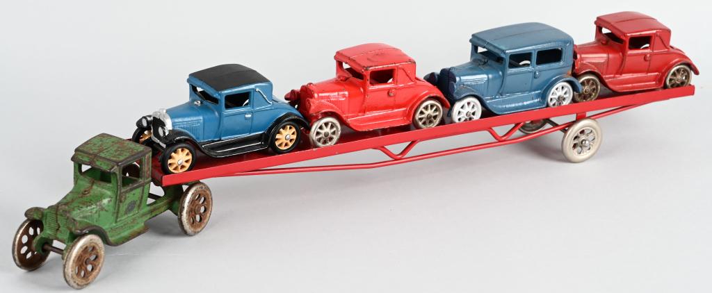 24" ARCADE 1930s cast iron CAR HAULER & 4 CARS: Scarce 1930s Arcade 24" Car Hauler. Comes with 4 cars. Cab is all original. Trailer is correct reproduction. Comes with 4 original cars that are restored. A rare piece in any condition. Displays well.