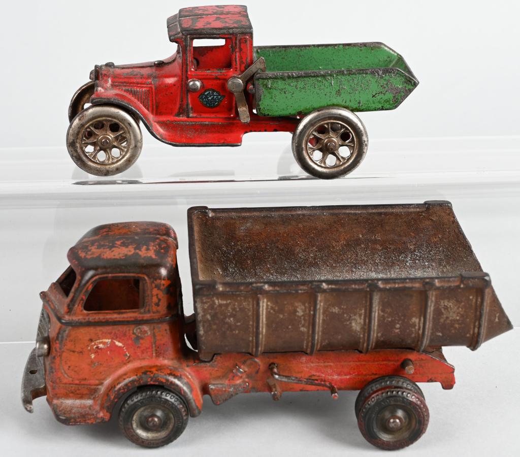 2- ARCADE 1920's-30's cast iron DUMP TRUCKS: Lot includes 6 3/4" Ford Model A Dump truck, along with 9" International Dump truck. The Model A is all original with no cracks or breaks. The International has some touch up and is missing the bed sp