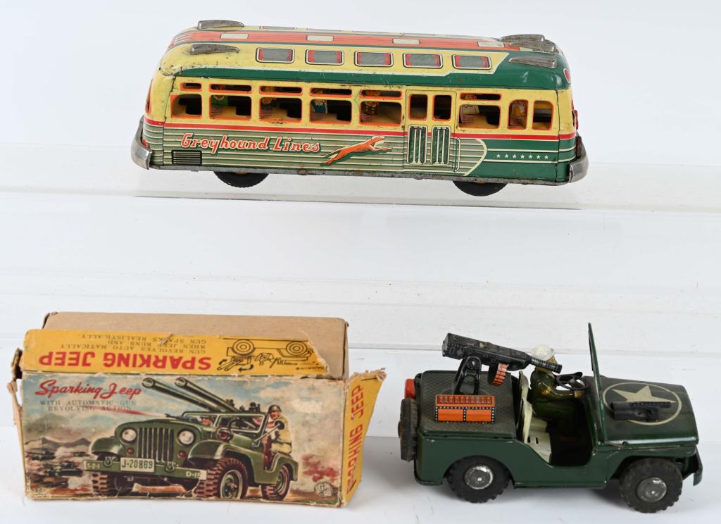 2- VINTAGE JAPAN TIN TOYS: Lot includes a 12 1/2" tin Greyhound bus with passengers, along with a Sparkling Jeep n the original box. The friction works on the Jeep, but does not on the bus. Condition varies, bus ahs wear and so