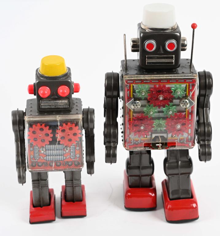 2- GEAR ROBOTS: Both all original. Includes windup Gear Robot. Working with crack in chest plate. Plus battery operated Gear Robot not working with some corrosion in battery box. Largest 11 1/2" Very Good