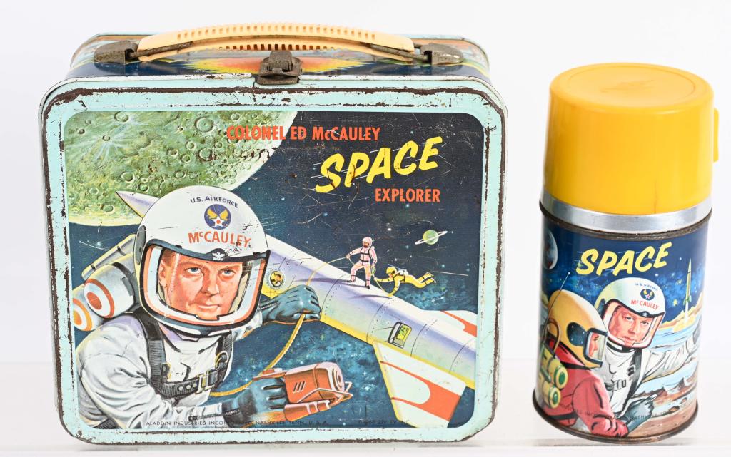 1960 COL. ED McCAULEY SPACE EXPLORER LUNCH BOX: Scarce original box with thermos. Has general wear, some paint loss and scattered light rust. Cover has split near latch. Good-Very Good