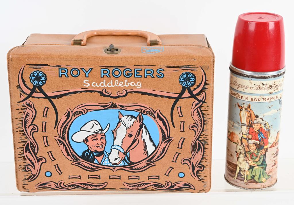 1960 ROY ROGERS VINYL SADDLE BAG LUNCH BOX: Nice original box with thermos. Box has light soiling, and thermos has surface wear and scattered rust spots. Very Good