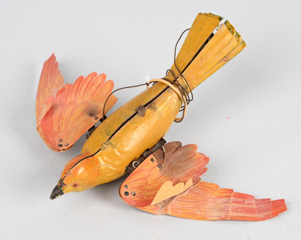 LEHMANN FLYING BIRD: All original and complete. Still has original paper wings. Very nice colors. Hard to find in this condition. 7" Excellent