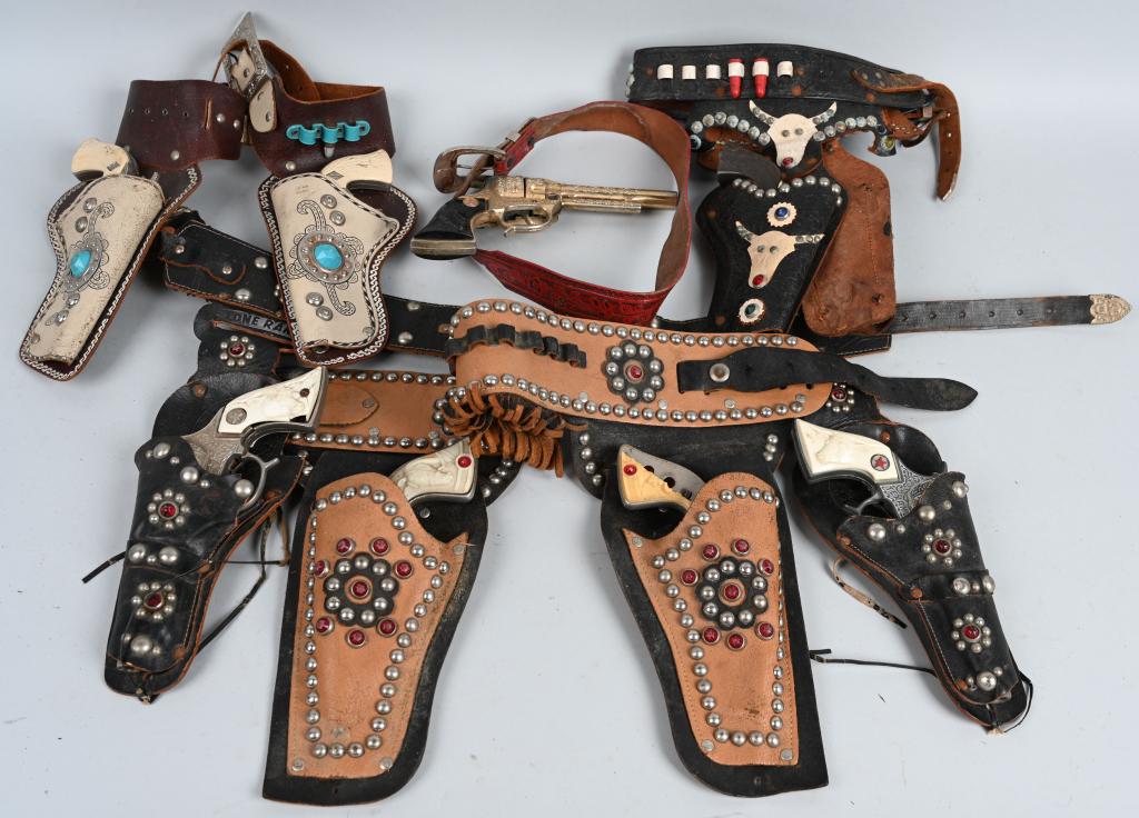 LOT OF VINTAGE CAP GUNS and HOLSTERS: Large lot of vintage cap guns and holsters in various conditions. Pistols are cast iron and diecast metal and most have condition issues. Holsters show wear. Good