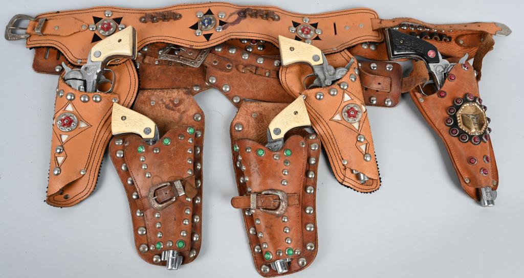 5- NICHOLS TOY CAP PISTOLS w/ HOLSTERS: Nice lot of Nichols cap pistols with leather holsters. Three of pistols worked, and 2 did not. Largest is 12", Very Good