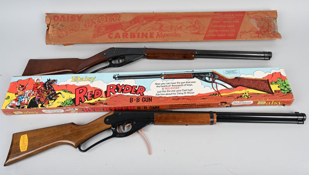 2- DAISY RED RYDER BB GUNS w/ BOXES: Lot includes a vintage Model 40 with plastic stocks in the original box, along with a 1970's example with wood stocks in a colorful box. This gun has the original receipt dated April 21, 1976. Both wo