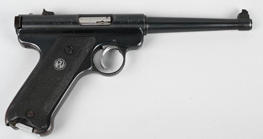 RUGER .22 SEMI-AUTOMATIC PISTOL: SERIAL 11-98113. BARREL 6". CALIBER .22 LONG RIFLE. Standard fixed sight blue gun with black plastic grips and one magazine. A few age freckles, some high edge & muzzle wear and turning patina on grip