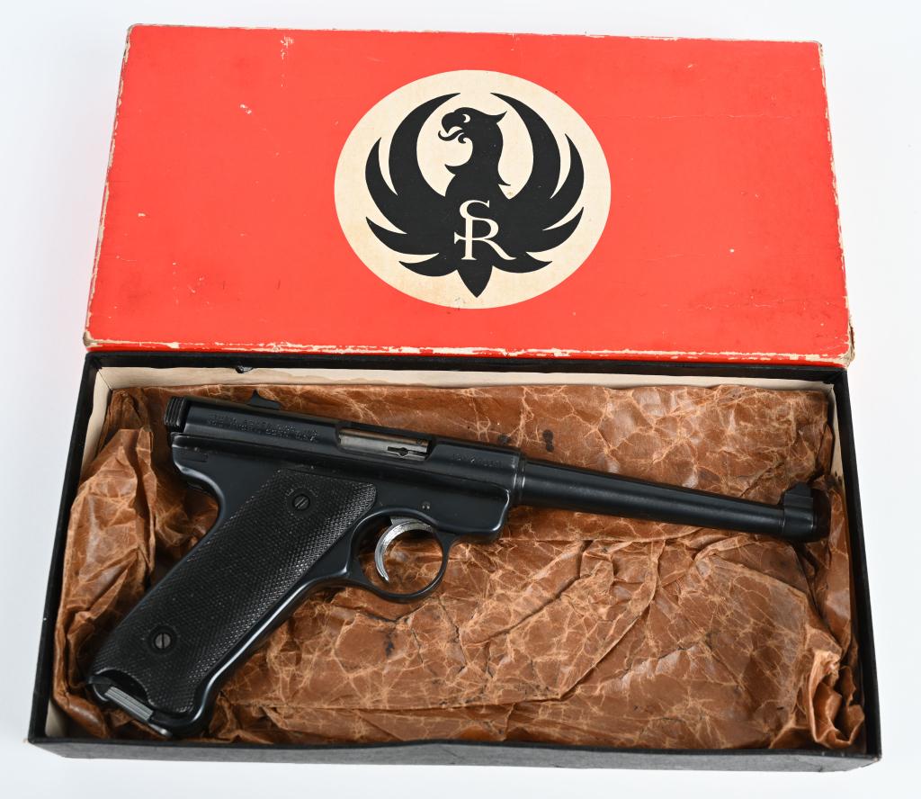 EARLY BOXED RUGER .22 SEMI AUTO PISTOL: SERIAL 10-27019. BARREL 6". CALIBER .22 LONG RIFLE. MADE IN 1968. Features blue finish, fixed sights, black logo plastic grips and one red logo magazine. Gun has rubs on both sides of forward frame ot
