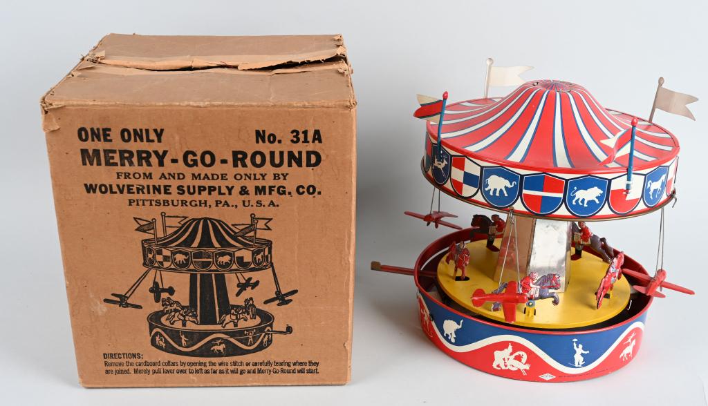 WOLVERINE Tin Windup MERRY GO ROUND w/ BOX: All original and complete. Has its flags. Works. Very nice colors. Boxed 13" Excellent