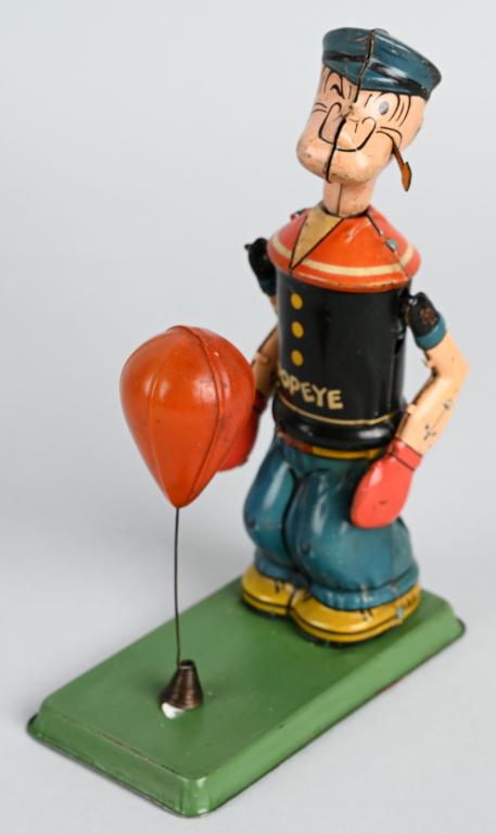 CHEIN Tin Windup POPEYE FLOOR PUNCHER: Scarce early Popeye toy. All original with tin Popeye and celluloid punching bag. Toy has nice colors. Windup works. 7 1/2" Very Good-Excellent