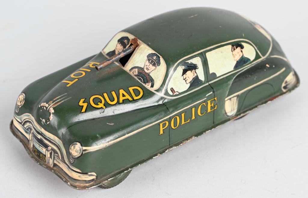 MARX PROTOTYPE TIN FRICTION POLICE RIOT SQUAD CAR: Nice Marx Prototype. Tin friction car that hand painted with Police Riot Squad. Has detailed Policeman in the windows of the car. Has some production marking on the bottom of the car but mostly flaked