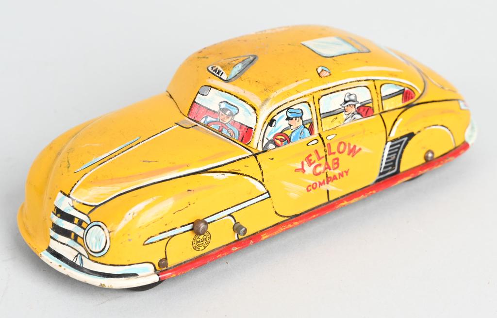 MARX PROTOTYPE TIN WINDUP YELLOW TAXI: Unique Marx Prototype. Tin windup Yellow Taxi that has hand painted details. One side has very nice details other has been left mostly original. Marked on bottom 3363X GLEN 1-5-49. Has front wheel dri
