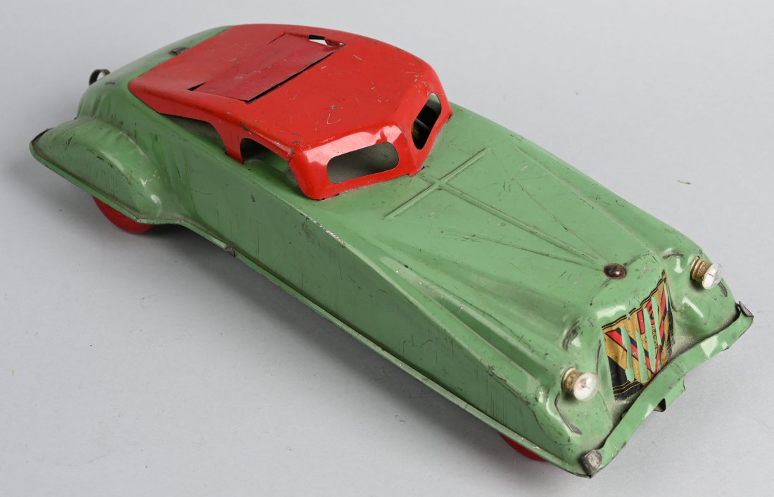 BUFFALO Tin Windup AUTOMOBILE w/ ELECTRIC LIGHTS: Unusual original car with pull windup in back typicalof Buffalo Toys. This version has electric headlights. Windup works. 15" Excellent (From the Danny Kubert Collection)