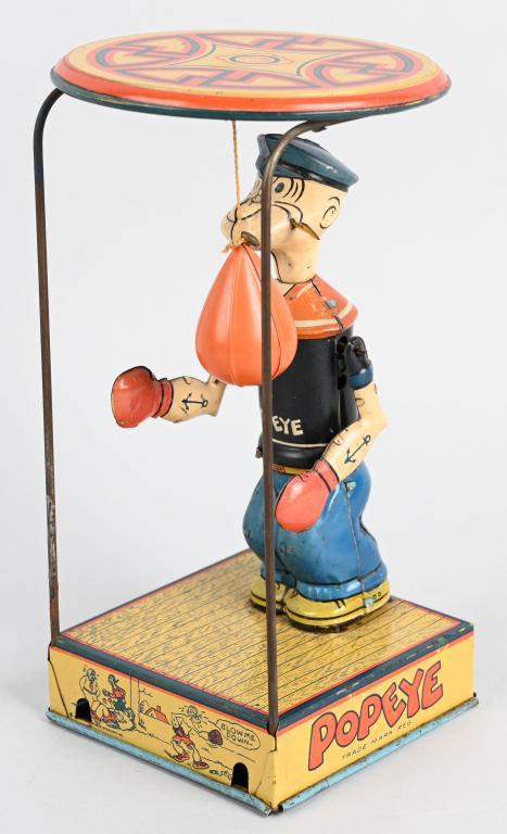 CHEIN Tin Windup POPEYE OVERHEAD PUNCHER: One of the most sought after early Popeye toys! The Popeye over head puncher. All original with very nice colors. Still has original celluloid punching bag. Windup works. A very nice example. 9 1/2" E