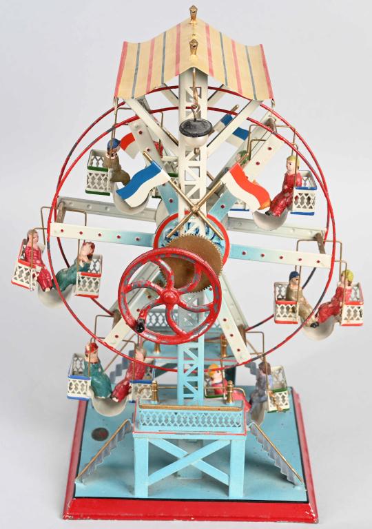 DOLL & CO TIN LITHO FERRIS WHEEL: Circa 1930 Doll & Co 729/3 Ferris Wheel with 6 seats containing 2 composition figures each. Still has beautiful original paint. Wonderful looking piece. 13 1/2" Excellent (From the Danny Kubert Collec