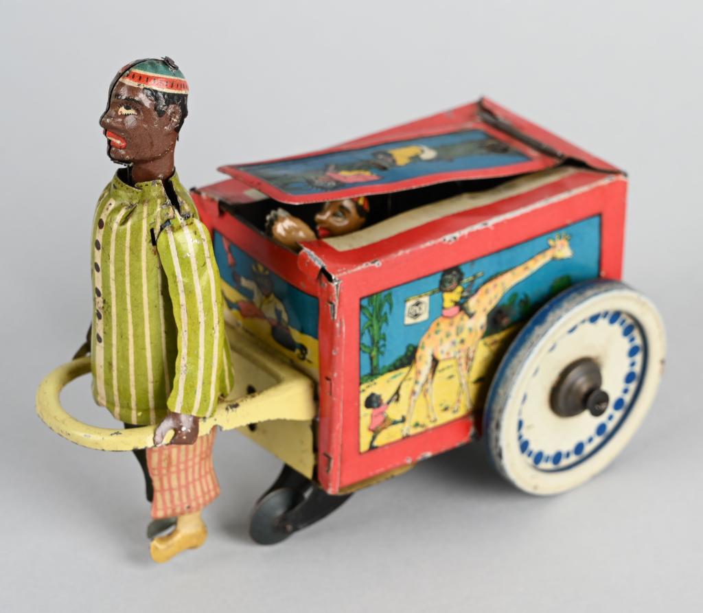 GEPPERT & KELCH Tin Windup MANDARIN PULLING CART: Wonderful G&K Mandarin Pulling Cart. Man pulls the cart along and a boy jumps out of the top. Very nice colors and graphics. Action works well. A very nice circa 1910 German Toy! 6 1/2" Excellent