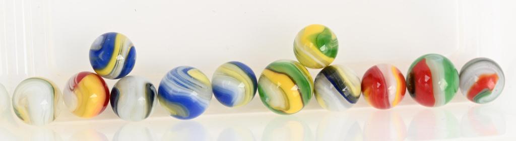 12- AKRO AGATE POPEYE MARBLES: Lot includes blue & yellow, hybrid blue gray and yellow, red and yellow, green and red and a 3/4" hybrid red, black and green. Size 5/8" to 3/4". Excellent