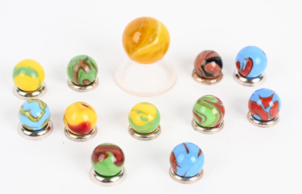 12- CHRISTENSEN AGATE MARBLES: Lot includes a salmon and black flame, 10- multicolor swirl and a near 1" electric yellow slag that has a 5/16" surface blow out. Sizes 19/32" to 63/64". Good-Excellent