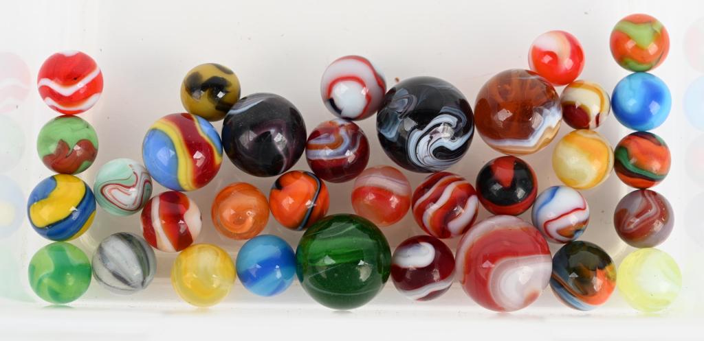 34- MACHINE MADE MARBLES: Nice lot includes slags, Akro corkscrews, Pettier yellow bee, liberties and ketchup and mustard. 17/32" to 1" diameter. Excellent