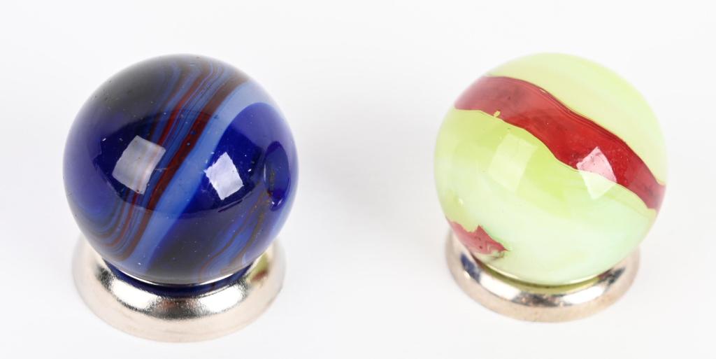 2- AKRO AGATE OXBLOOD MARBLES: Lot includes hard to find blue oxblood, along with a lemonade oxblood. Both are 3/4" diameter. Excellent
