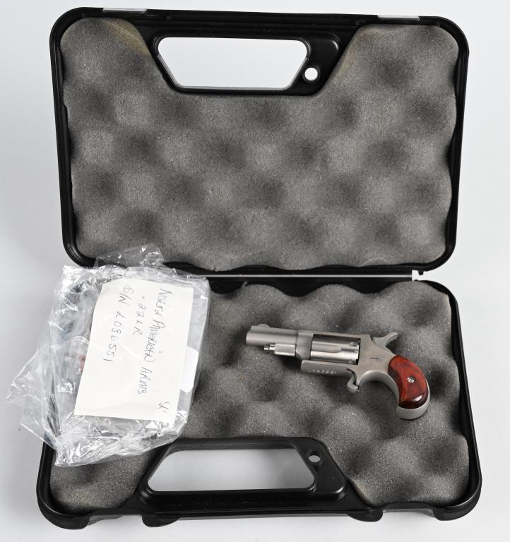 BOXED NORTH AMERICAN ARMS DERRINGER: SERIAL L086551. BARREL 1.5". CALIBER .22 LR. Made of stainless steel and features a five shot fluted cylinder, single action, spur trigger with fixed front sight and birds head wood grips. Gun appears