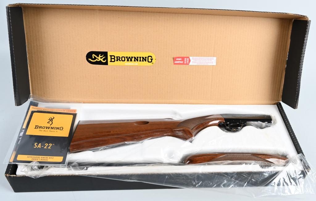 BOXED BROWNING SA22 SEMI AUTO 22 SHORT RIFLE: SERIAL 01933ZZ212. BARREL: 22" CALIBER 22 SHORT. Features blued finish, glossed and checkered wood stock, tube mag fed from butt stock, scroll engraved receiver. Comes in factory cardboard box with or
