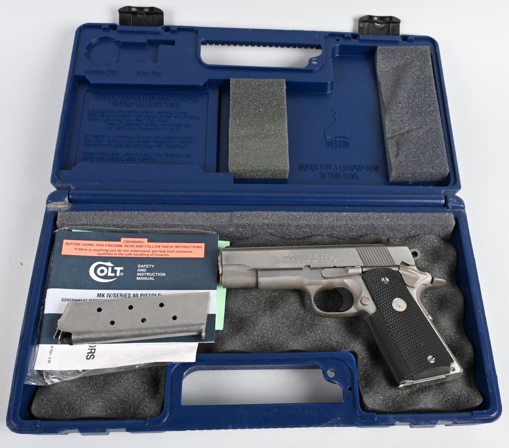 BOXED STAINLESS COLT COMMANDER MK IV 1911 PISTOL: SERIAL FC17997E. BARREL 5". CALIBER .45 ACP. Stainless version of the old Model 1911-A1 that features a beveled ejection port, bobbed hammer, white dot sights, beaver tail safety and rubber grips. Sli