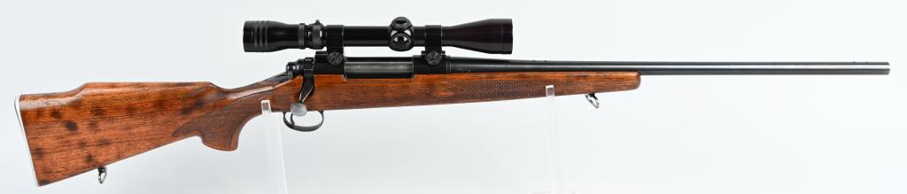 REMINGTON MODEL 700 BOLT ACTION RIFLE: SERIAL 218611. BARREL 22". CALIBER 30-06. Earlier rifle features fine pressed checkered walnut stock, blue finish, metal plate, sling swivels, barrel sights removed and now sporting a 3x9 Redfield sco