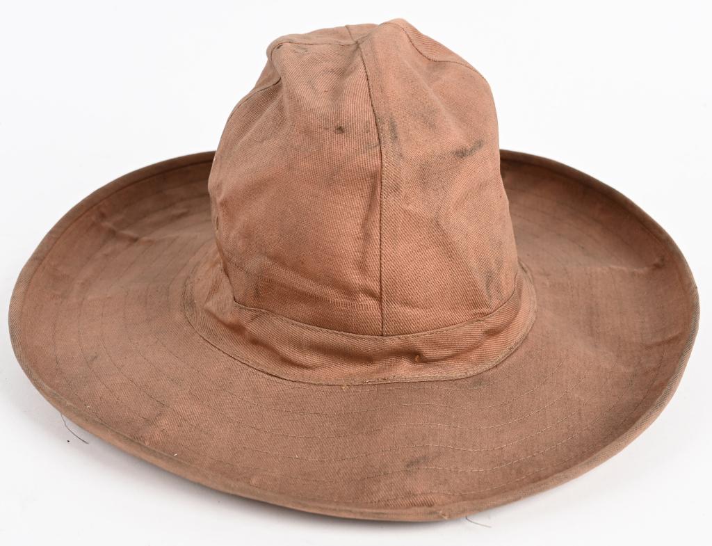EARLY SPAN AM DAISY MAE HAT IN HBT W/ SWEATBAND: This very large brimmed HBT or herringbone Twill Daisy Mae hat is in exceptional condition. Hat is fully lined in a heavy white gauze material with a full leather sweatband, size marked 7 1/4. Has dua