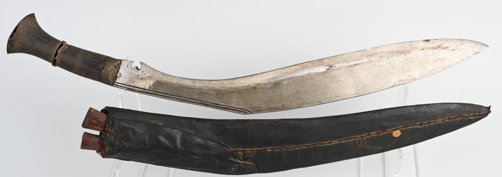 19TH CENTURY NEPALESE KUKRI KNIFE WITH SIDE KNIVES: Vintage Nepalese kukri (or khukuri ) knife with leather sheath and two side knives. The large knife is 16" overall with a 12" blade. The grips are wood with a metal pommel. The small knives are 6.25" 