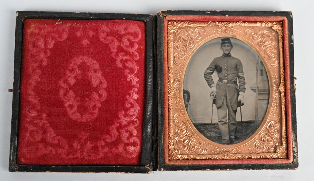 CIVIL WAR 1/6 PLATE TINTYPE FEDERAL ARMED NCO: Nice original 1/6 plate image of a Union Sergeant wearing a frock coat and kepi. His M1839 US oval belt plate is visible and he is holding a unsheathed M1840 NCO sword. On the right side of the image