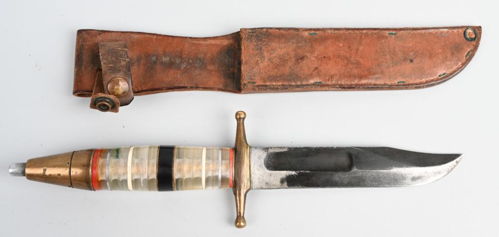 WWII US THEATER MADE COMBAT KNIFE WITH FUZE POMMEL: One of a kind, fascinating WWII era theater made trench combat knife. The blade is taken from a Ka-Bar or Navy Mk. II. measuring 6.5" with a 2.5" clip point. The handle is stacked plexiglass - likely