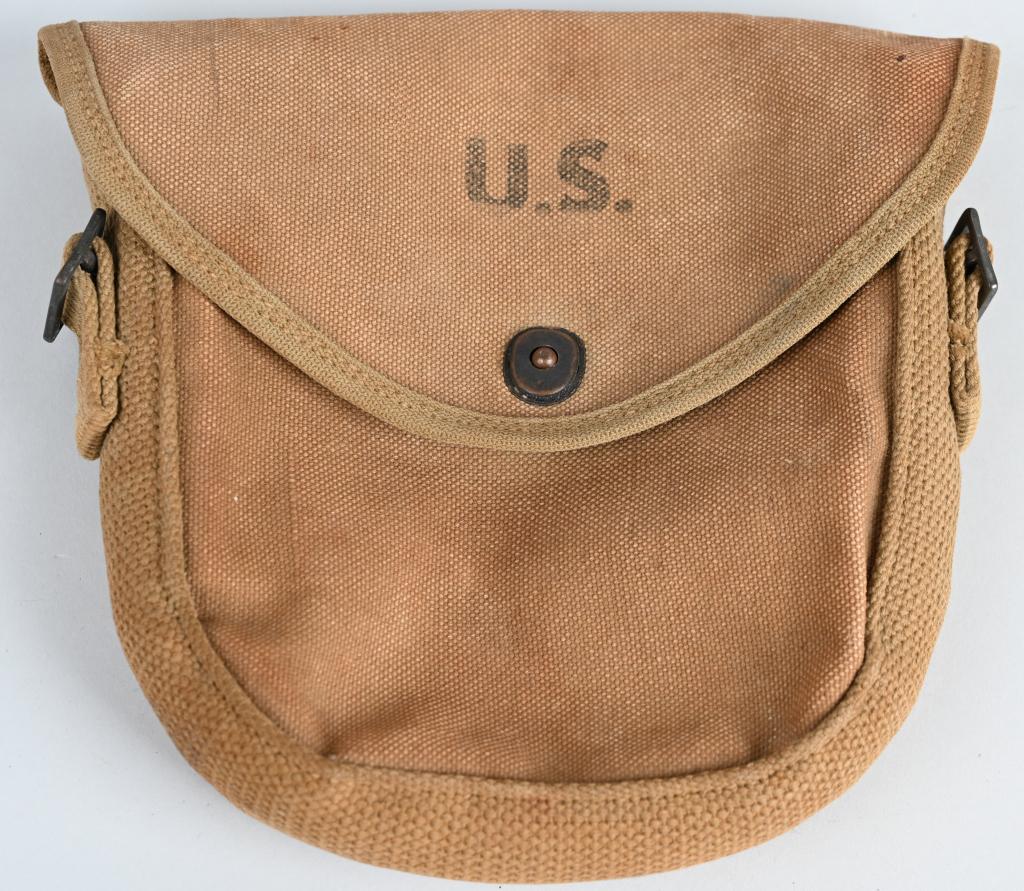 WWII US THOMPSON DRUM MAGAZINE POUCH 1942 DATED: Original US WWII Thompson Drum Magazine Pouch Dated 1942. Nicely used drum magazine pouch that is maker marked and dated 1942 under the flap. There are no holes or rips or tears. Very good condition.