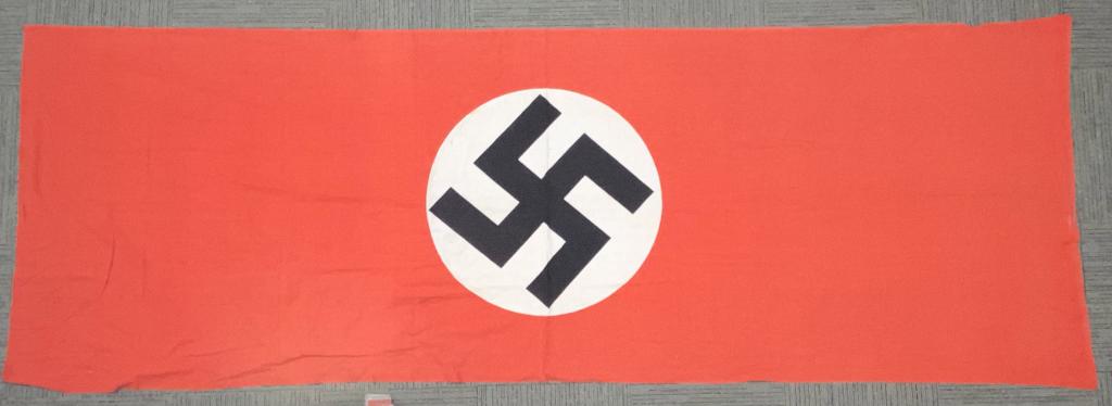 WWII NAZI GERMAN NSDAP NATIONAL FLAG WW2: Multi-piece cotton construction banner approximately 59 X 172 inches. To both its red fields are sewn are white disks with a printed mobile swastikas in black. Shows the expected period use and wear b