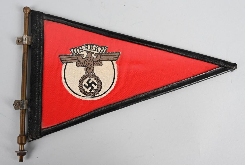 WWII NAZI GERMAN NSKK VEHICKLE PENNANT W/ FRAME: A multi-piece cotton construction pennant, 31cm across with a 17cm tall hoist edge. Sewn to both sides of its red field is a 85mm diameter white disk, upon which is machine woven a copper-colored, spr