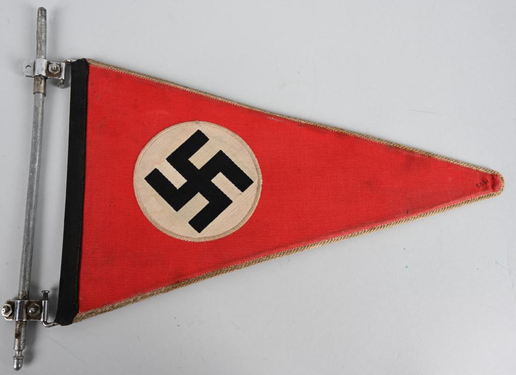 WWII NAZI GERMAN NSDAP VEHICKLE PENNANT W/ FRAME: A cotton covered double sided vehicle pennant measuring approximately 35cm x 20cm has a 10cm white discs with a black mobile swastika. The outer edges of the pennant are trimmed with white cording. Th