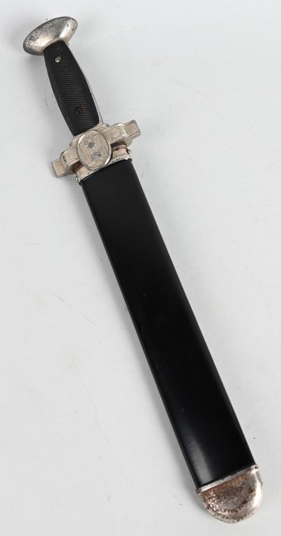 WWII NAZI GERMAN RED CROSS HEWER DAGGER: WWII Nazi Red Cross hewer dagger. Sawback spine with a black bakelite handle, Nazi eagle, thick pommel, black painted steel scabbard with lug for belt loop. Shows very light age. Measures approximatel