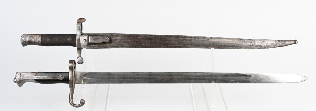 2 BAYONETS - PORTUGESE M1881 & ITALIAN VETTERLI 71: Pair of long-blade bayonets. Portuguese Model 1881 with muzzle ring sight, wood grips, steel scabbard, 18.4" blade and 24" overall length and an Italian Vetterli Model 1871 bayonet with no scabbard, w