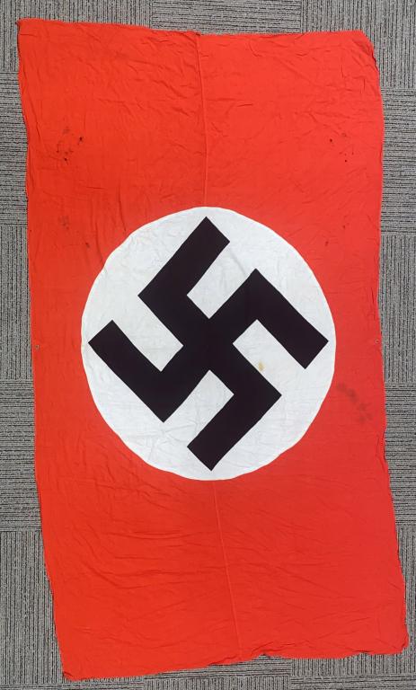 WWII NAZI GERMAN NSDAP WALL BANNER: Multi-piece cotton construction banner approximately 60 X 108. To both its red fields are sewn an 47 inch diameter white disks, with a printed mobile swastikas in black. Shows the expected period use 