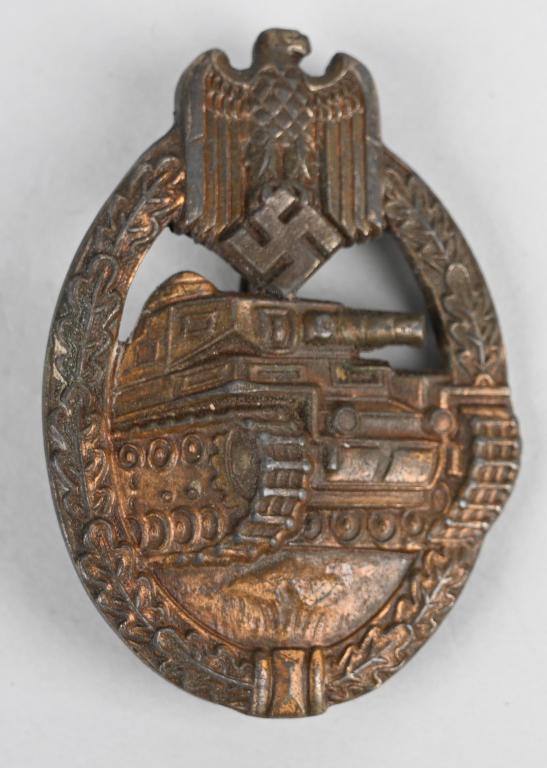 WWII NAZI GERMAN PANZER ASSAULT BADGE BRONZE EWE: Die struck, alloy construction, solid backed, badge with a bronze washed finish features a vertically oval, oak-leave wreath with a Wehrmacht style eagle with down-swept wings, clutching a canted swas