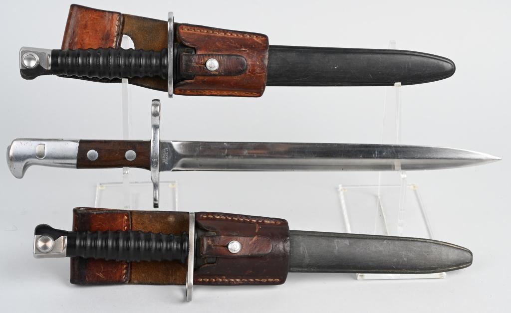 3 SWISS MILITARY RIFLE BAYONETS SCHMIDT RUBIN SIG: 3 Swiss military rifle bayonets. 2 different versions of the Sig M1957 bayonets, both of which have plastic grips and scabbard, and leather frog with 9.4" blades, 14.4" overall length. Also comes with