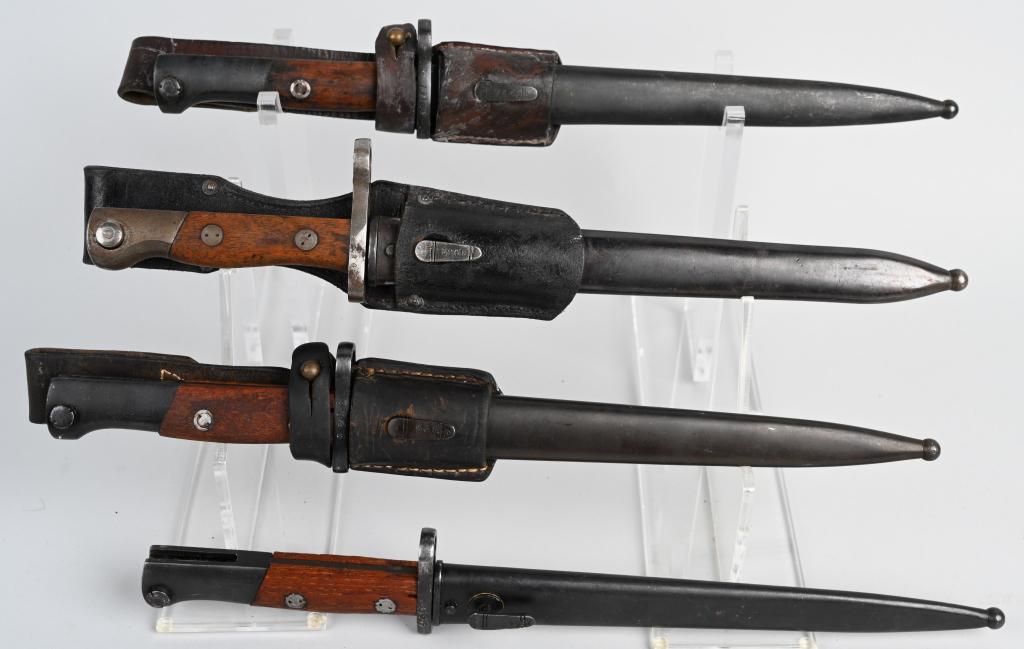 4 YUGOSLAVIA MILITARY RIFLE BAYONETS M1924 & 7mm: FOUR Yugoslav military rifle bayonets. Three have leather frogs. Three Model 1924 / M24 style and one 7mm bayonet. All four feature wood grips, steel scabbards, and have 9.8" blades, 14.8" overall len