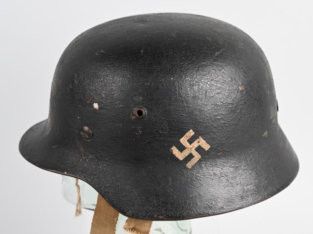 WWII GERMAN M35 HELMET WITH PARTIAL LINER NS66: WWII German helmet with partial liner. The original helmet shell is an NS66. The stamped, sheet steel construction helmet has a very old black over paint. The right side of the helmet has a hand paint