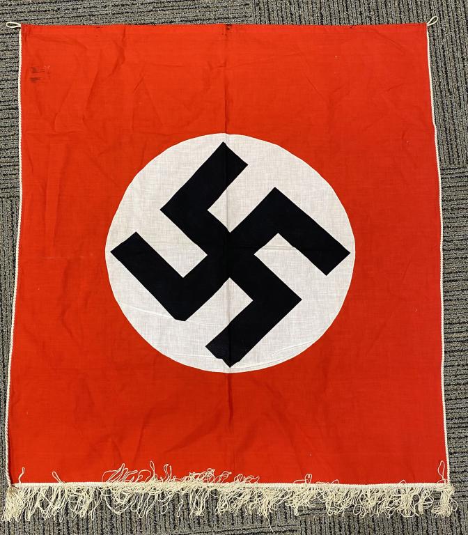 WWII NAZI GERMAN NSDAP PODIUM BANNER 31 X 34: Approximately 31 X 34 inches single sided multi-piece cotton/rayon construction banner features a red base field with a separate, white circular field to the center with a black printed, canted swasti