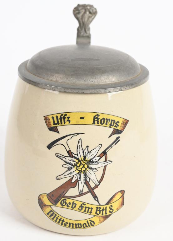 WWII NAZI GERMAN COMMEMORATIVE BEER STEIN: (Stein) Lidded Ceramic beer stein, 50mm tall, with commemorative markings "Uffz - korps" "Geb fm Btl 8 Mittenwald" graphics depict implements of a Gebirgsjäger soldier including his ice pick and rifl