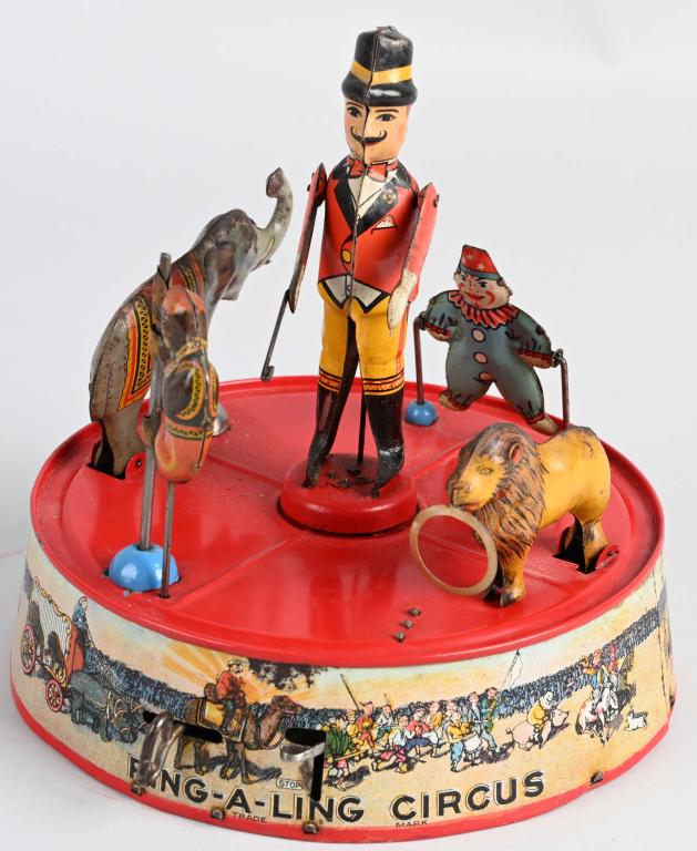 MARX TIN WINDUP RING A LING CIRCUS: Very nice all original example. Great colors and graphics. Windup works. 7 3/4" Very Good-Excellent