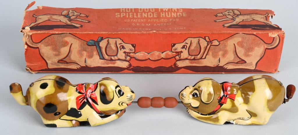 GERMAN TIN WINDUP HOT DOG TWINS w/ BOX: Pair of tin windup Dogs fighting over Hot Dogs. All original and works. Boxed 10 1/2" Excellent