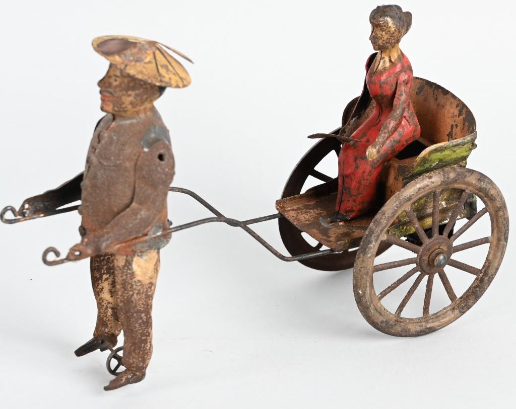 GERMAN TIN WINDUP COOLIE PULLING WOMAN RICKSHAW: All original with very nice details. Windup works. Unusual toy. 9" Very Good